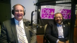 Comcast VP Larry Williamson (L) and Heart Div PR Head Randy Jones (R) tell Amos about Comcast's Olympic Services