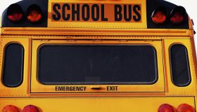 Front of yellow school bus, close-up, part of