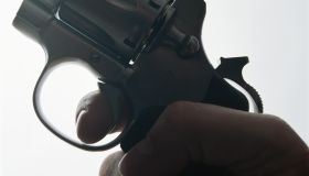 Hand holding gun, close-up
