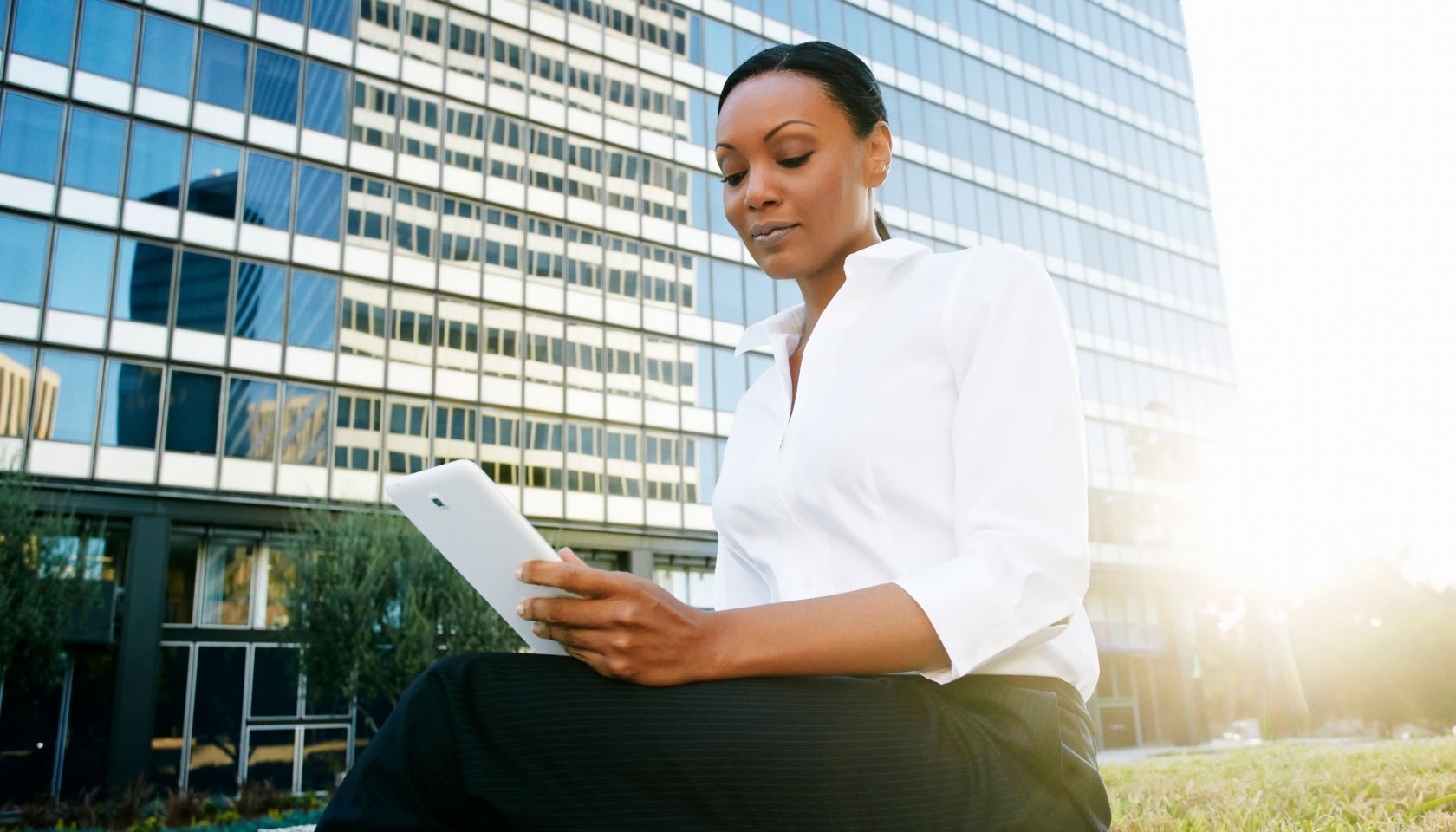 Black businesswoman using digital tablet outdoors