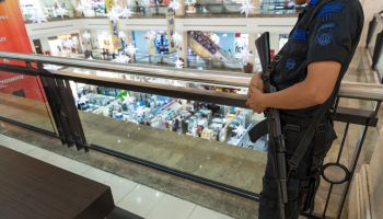 Man with an assault rifle in a supermarket