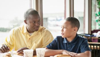 Father dining with son at fast food restaurant