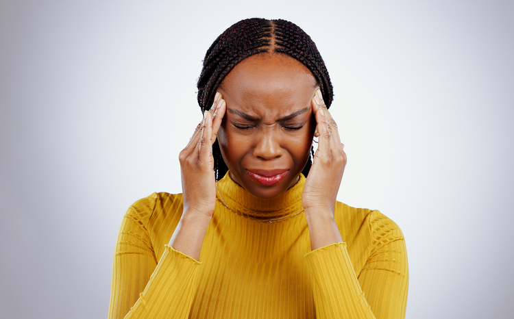 Stress, pain and black woman with a headache, frustrated and tension on a white studio background. African person, girl and model with a migraine, depression and strain with mind fatigue or emergency