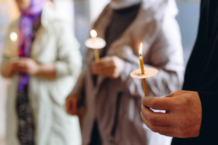 hand with church candle