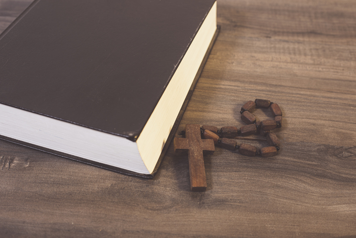 Book and cross on the table
