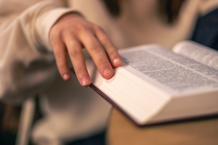 Bible close-up. Christianity concept. Reading the Holy Bible. Bible in women's hands.