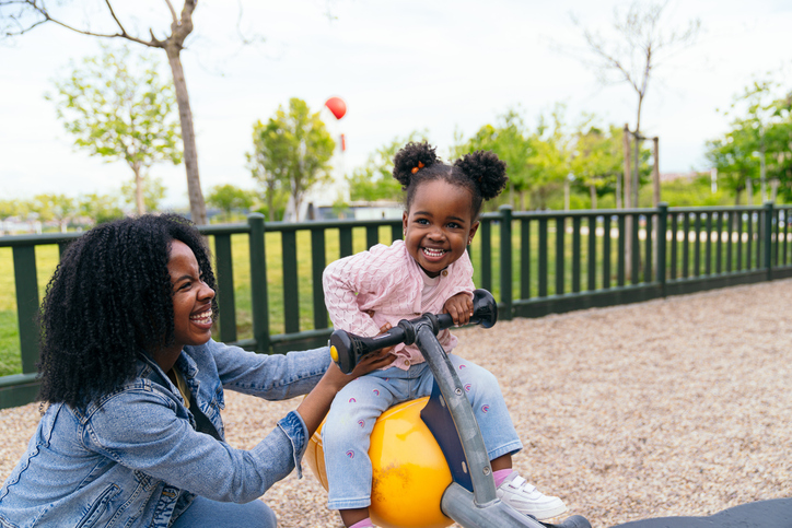 African mother and daughter having fun at the playground