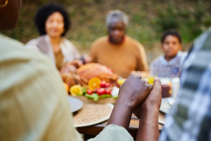 Praying before Thanksgiving lunch at picnic table!