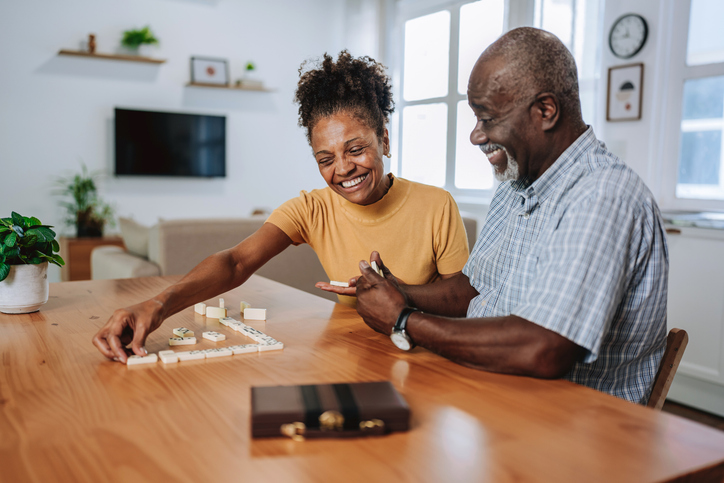 Elderly couple playing dominoes